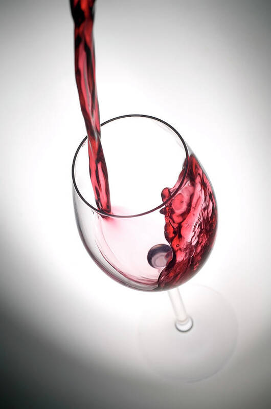 Alcohol Poster featuring the photograph Pouring Red Wine Into A Glass by Stockcam