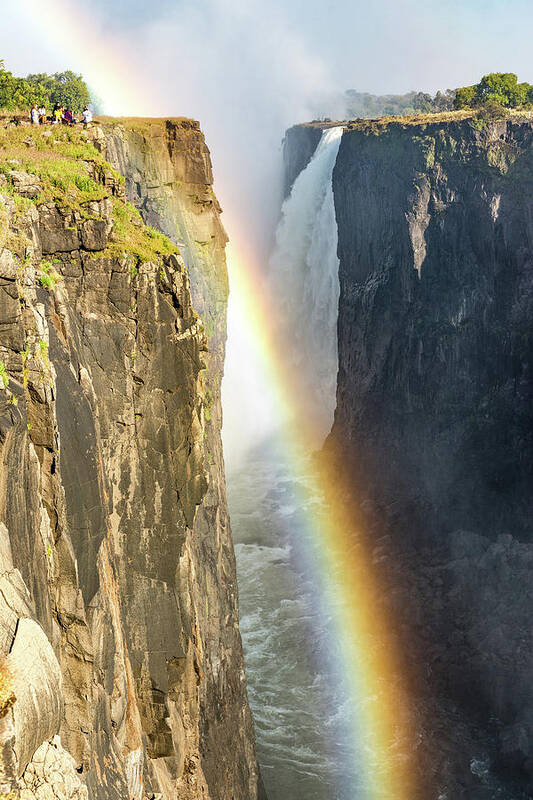Blue Poster featuring the photograph Rainbow at the Victoria Falls, Zimbabwe, Africa by Francesco Riccardo Iacomino