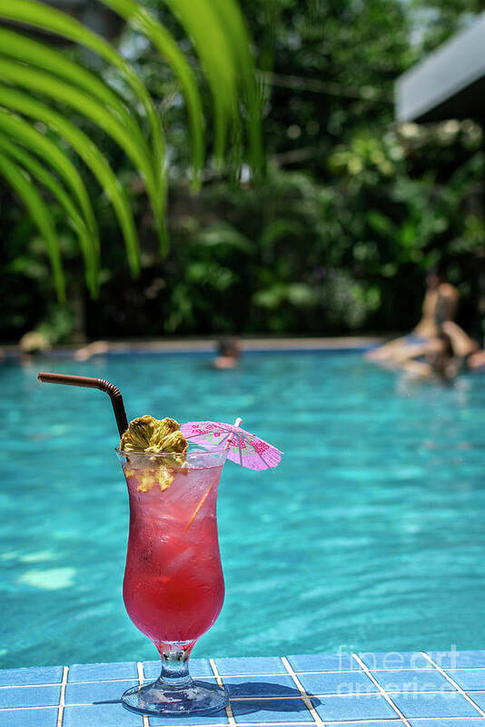 Tropical Sinagpore Sling Cocktail In Tall Glass By Swimming Pool