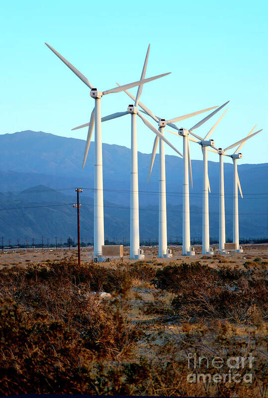 Wind Poster featuring the photograph A row of wind turbines to produce green energy in the Palm Springs area of California.	 by Gunther Allen