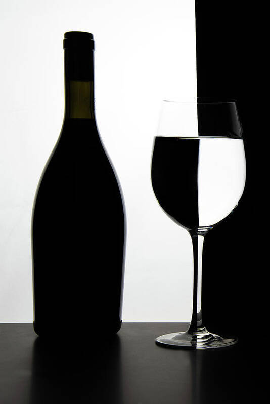 Wineglass Poster featuring the photograph Black bottle and empty glass of wine by Michalakis Ppalis