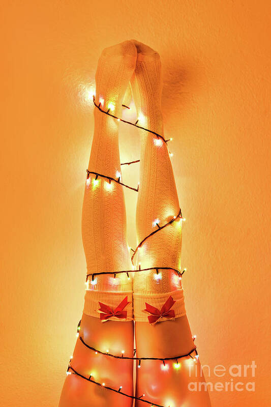 Christmas Poster featuring the photograph Female legs wrapped with christmas tree lights by Mendelex Photography