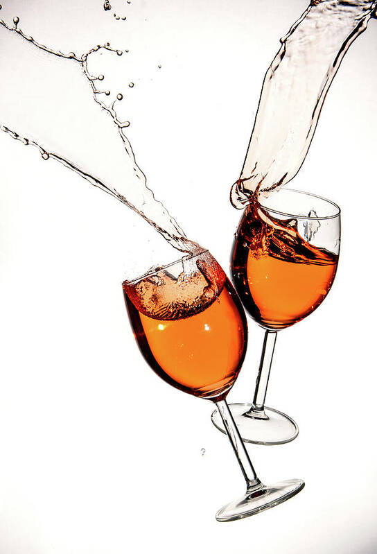 Alcohol Poster featuring the photograph Red wine in glasses with splashes on a white background isolated by Michalakis Ppalis