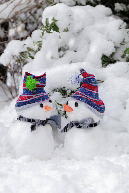 Snowman Poster featuring the photograph Two cute little snowmen dressed for snow by Simon Bratt