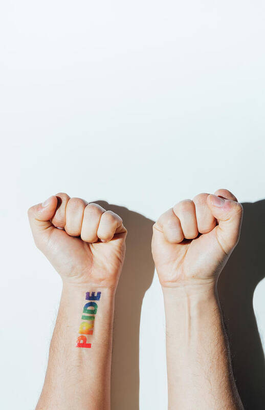 Gay Poster featuring the photograph Gay Guy's Hand With A Tattoo That Says Pride And Nail Polish. by Cavan Images