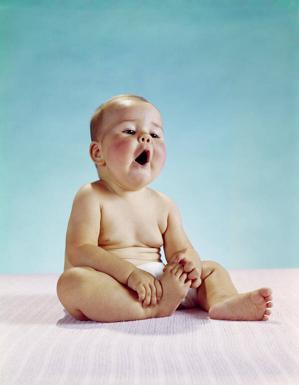 Photography Poster featuring the photograph 1960s Tired Baby Sitting Holding by Vintage Images