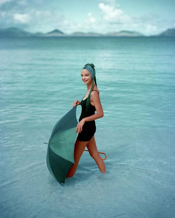 Fashion Poster featuring the photograph A Model In The Sea With An Umbrella by Richard Rutledge