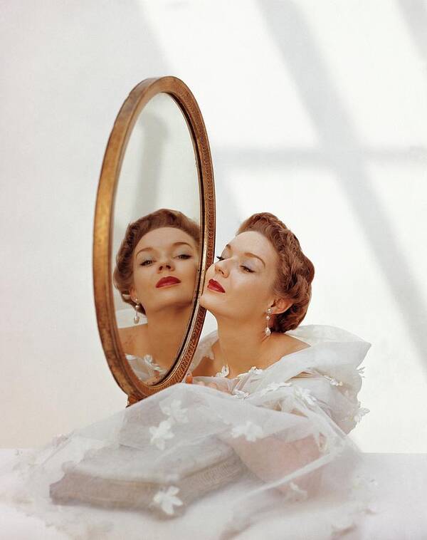 Fashion Poster featuring the photograph A Model Looking Into A Mirror by John Rawlings