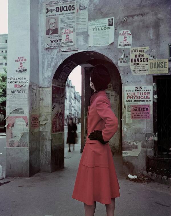 Accessories Poster featuring the photograph A Model Wearing A Red Coat On A Street In Paris by John Rawlings