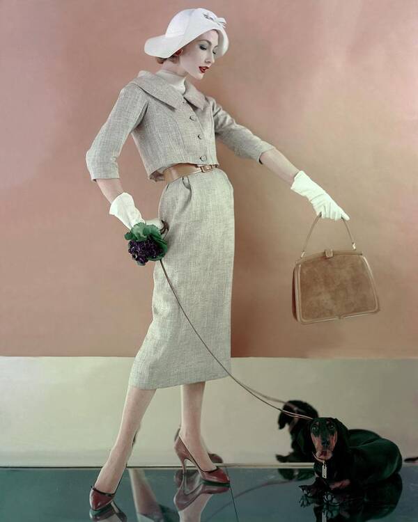 Fashion Poster featuring the photograph A Model Wearing A Tweed Jacket And Skirt by Karen Radkai