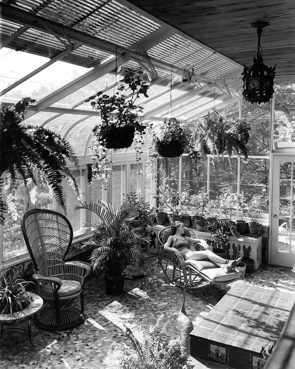 Architecture Poster featuring the photograph A Woman Resting On A Chair Inside A Greenhouse by Eric J. Baker