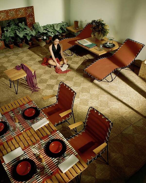 Model Poster featuring the photograph A Woman Sitting On The Floor Of Her Living Room by Herbert Matter