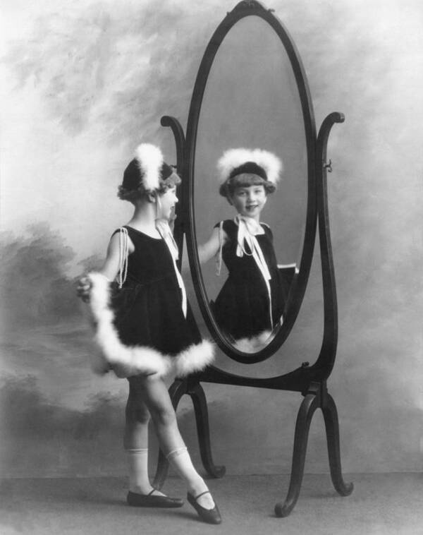 1035-692 Poster featuring the photograph A Young Girl In A Mirror by Underwood Archives