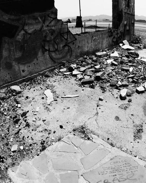 Left Behind In The Rubble Poster featuring the photograph Left Behind in the Rubble -- Motorcyclist and Graffiti in Amboy, California by Darin Volpe