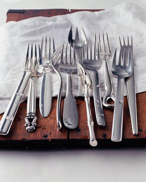 Kitchen Poster featuring the photograph Various Forks On A Wooden Board by Romulo Yanes