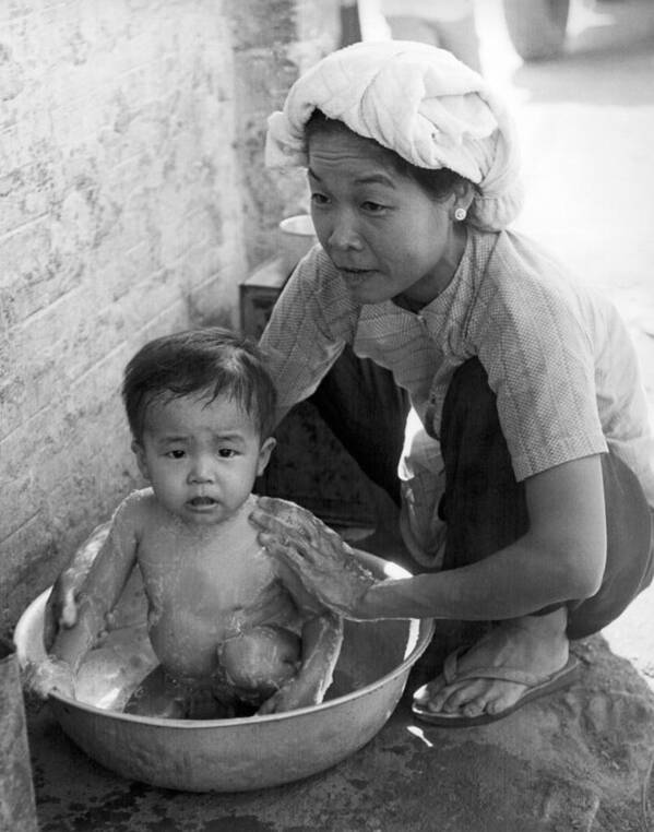 1960s Poster featuring the photograph Vietnamese Orphan Bathing by Underwood Archives