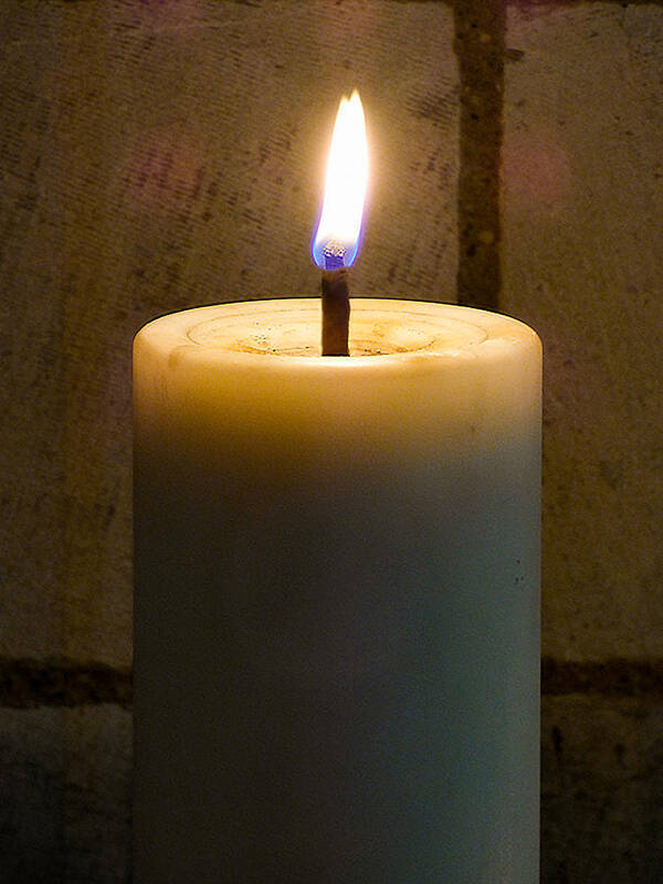 Alight; Blue; Brown; Burning; Candle; Fire; Light; Night; Stone; Texture; Wall; White; Yellow; Flame Poster featuring the photograph Candle Light by Steve Taylor