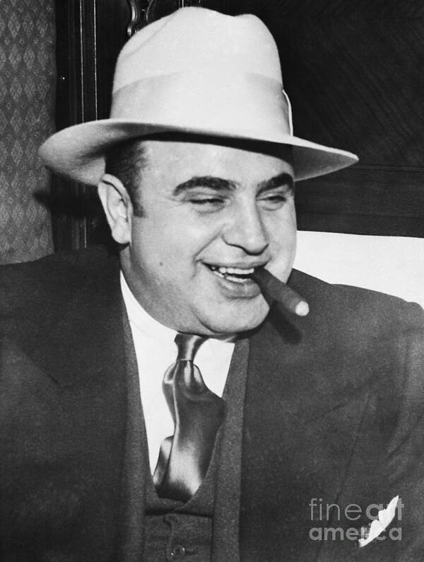 Al Capone Poster featuring the photograph Gangster Al Capone Smoking Cigar #1 by Bettmann
