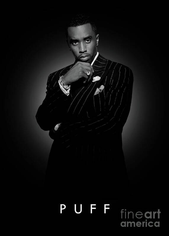 Musician P.Diddy poses in front of a giant poster advertising his