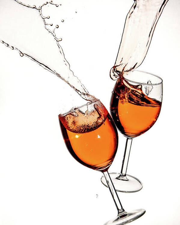 Alcohol Poster featuring the photograph Red wine in glasses with splashes on a white background isolated by Michalakis Ppalis