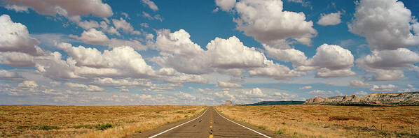 Scenics Poster featuring the photograph Desert Road With Cloud Formations Above by Gary Yeowell