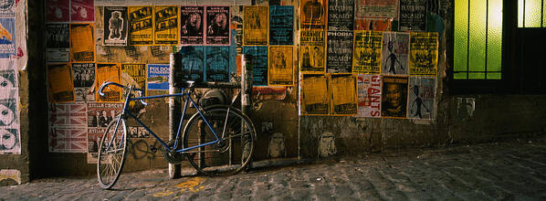 Photography Poster featuring the photograph Bicycle Leaning Against A Wall by Panoramic Images