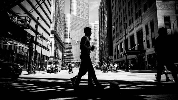 Black Poster featuring the photograph In the middle - Chicago, United States - Black and white street  by Giuseppe Milo