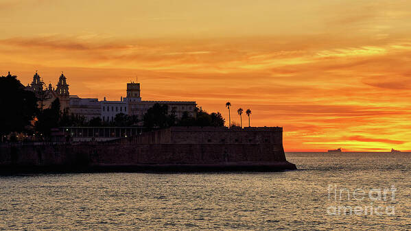 Andalusia Poster featuring the photograph Candelaria Fortress Silhouette at Sunset against Orange Sky by Pablo Avanzini