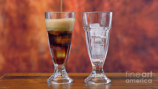 Cola Poster featuring the photograph Pouring cola soft drink on ice in tall cafe glasses. by Milleflore Images