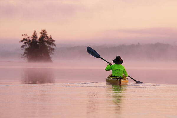 Birch Lake Poster featuring the photograph A Woman Kayaking In Birch Lake #1 by Christian Heeb