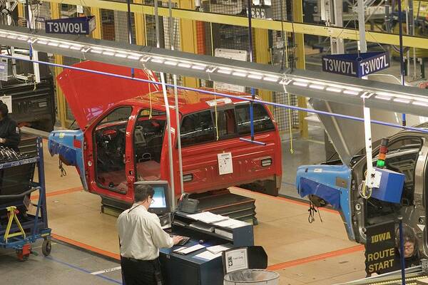 Human Poster featuring the photograph Truck Assembly Production Line #1 by Jim West