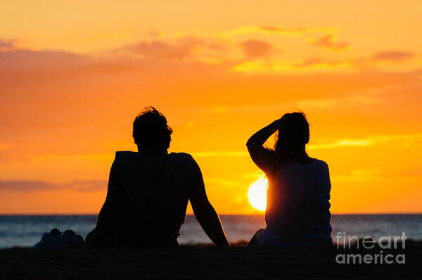 Hawaii Poster featuring the photograph Couple watching the sunset on a beach in Maui Hawaii USA #10 by Don Landwehrle