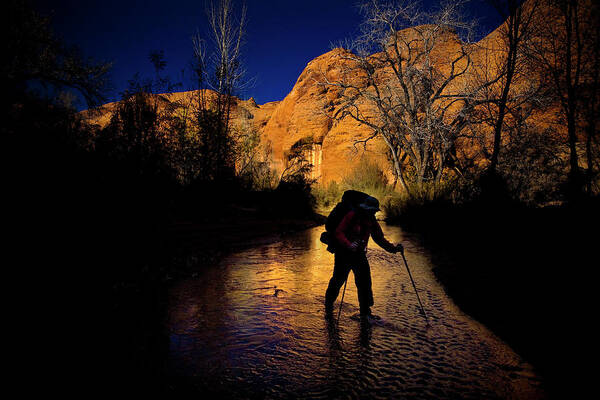 Afternoon Poster featuring the photograph A Man Hikes Through A Stream As The Sun by Kirk Mastin