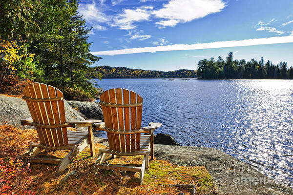 Chairs Poster featuring the photograph Adirondack chairs at lake shore 1 by Elena Elisseeva