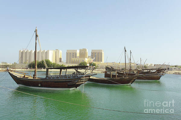 Dhow Poster featuring the photograph Dhows and Doha Port buildings by Paul Cowan