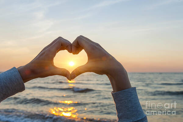 Heart Poster featuring the photograph Fingers heart framing ocean sunset by Elena Elisseeva