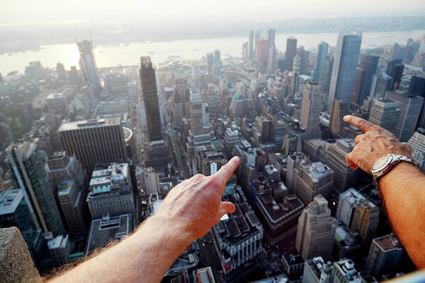 Mature Adult Poster featuring the photograph Hands Pointing At City As Seen From by Chris Tobin