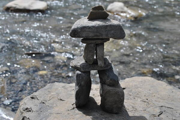 Inukshuk Poster featuring the photograph Inukshuk by the water by Jim Hogg