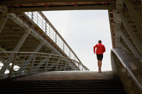 Steps Poster featuring the photograph Man Running Up A Bridge by Chris Tobin