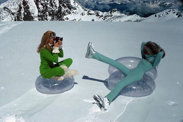 Fashion Poster featuring the photograph Models On Plastic Chairs With Snow In Switzerland by Arnaud de Rosnay