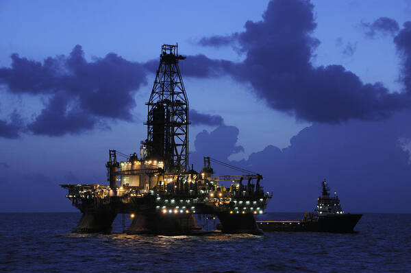 Deepwater Horizon Poster featuring the photograph Oil Rig and Vessel at Night by Bradford Martin