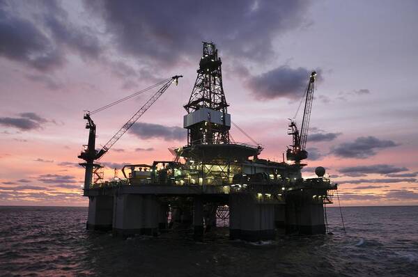 Oil Rig Poster featuring the photograph Oil rig at dawn by Bradford Martin