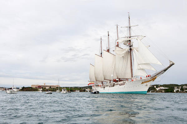 Bay Poster featuring the photograph Juan Sebastian de Elcano famous tall ship of Spanish navy visits Port Mahon in front of bloody islan by Pedro Cardona Llambias