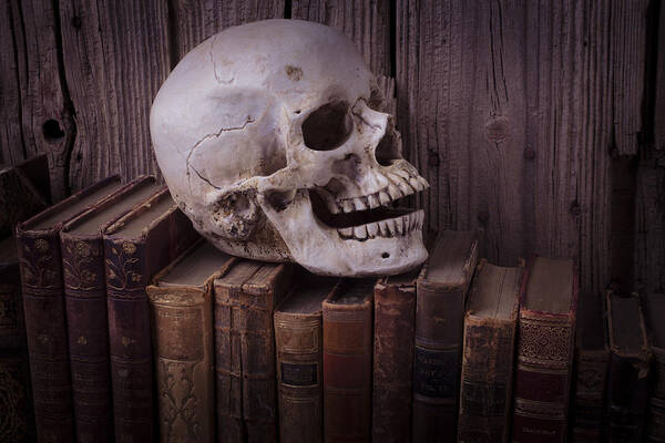 Skull Poster featuring the photograph Skull on old books by Garry Gay