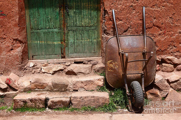 Wheelbarrow Poster featuring the photograph Rusty Wheelbarrow and Green Door by James Brunker