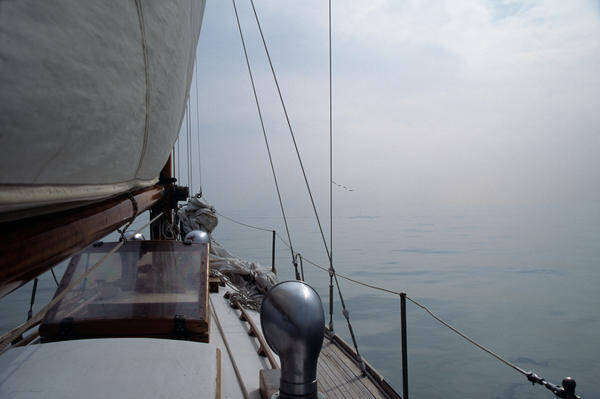 Sail Poster featuring the photograph Classic Wooden Sailboat with no Horizon off the Bow by John Harmon