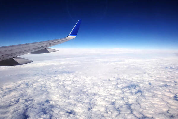 Airplane Poster featuring the photograph Flying Above The Clouds by Tracie Schiebel