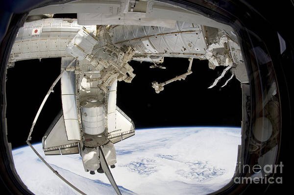 View From Space Poster featuring the photograph The Docked Space Shuttle Discovery by Stocktrek Images