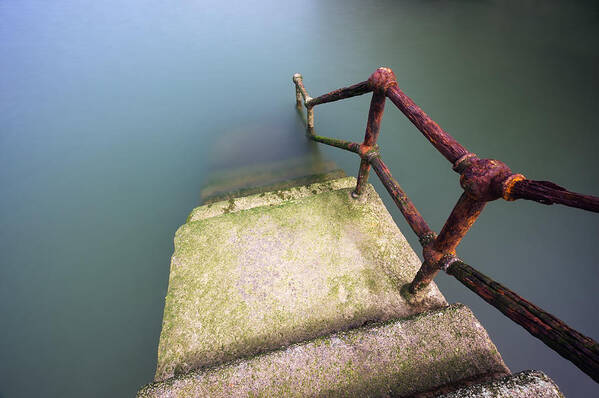 Railing Poster featuring the photograph Rusty Handrail Going Down On Water #2 by Mikel Martinez de Osaba