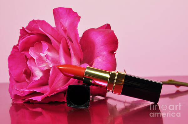 Pink Poster featuring the photograph A touch of femininity with a bright red luxury lipstick by Milleflore Images